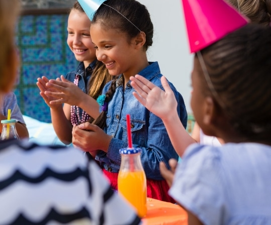 children-applauding-while-sitting-at-table